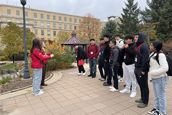 A group of precollege students with their tour guide.