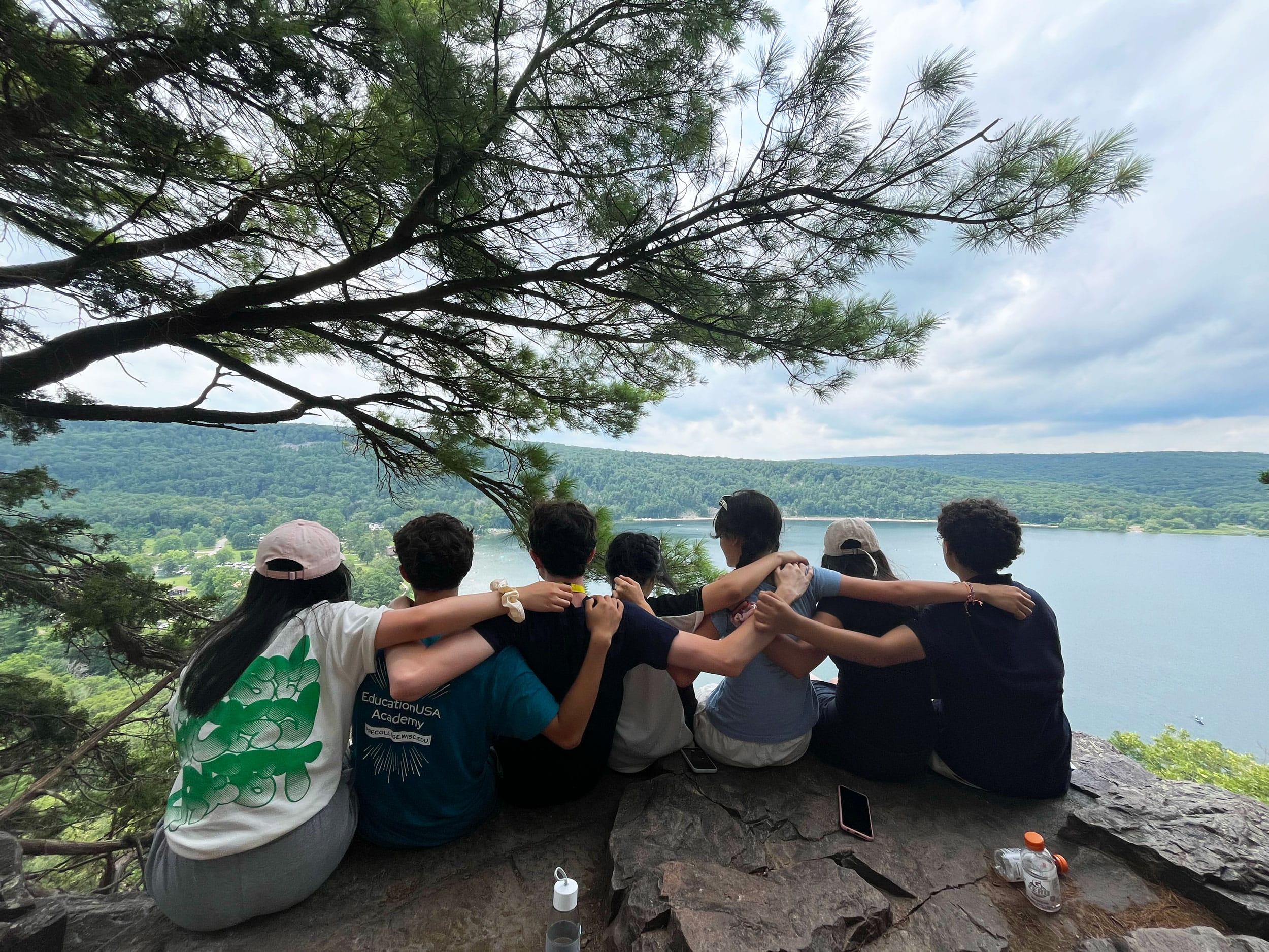 Precollege students sitting on an overlook at Devil's Lake State Park in Baraboo