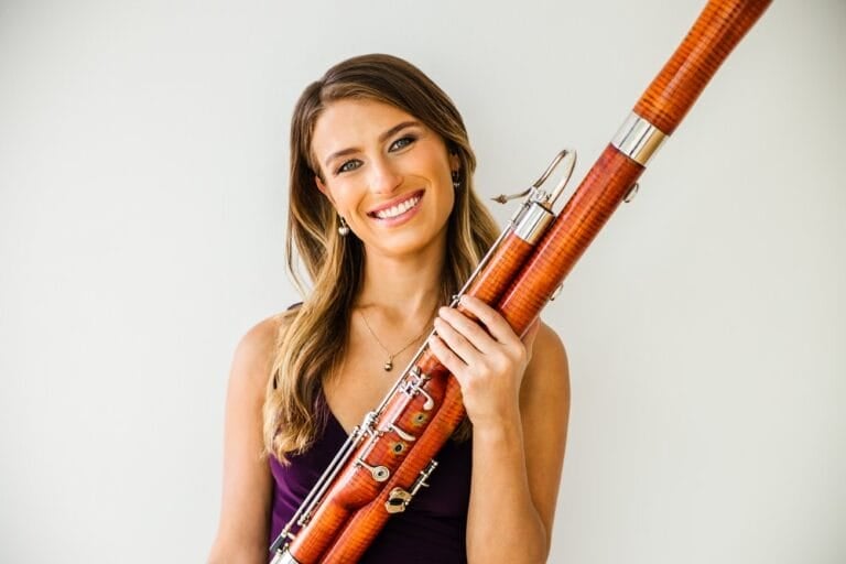 Eleni Katz posing for a picture holding her bassoon
