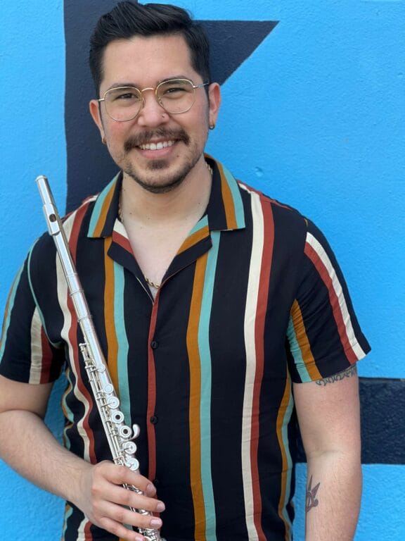 A man holding a flute