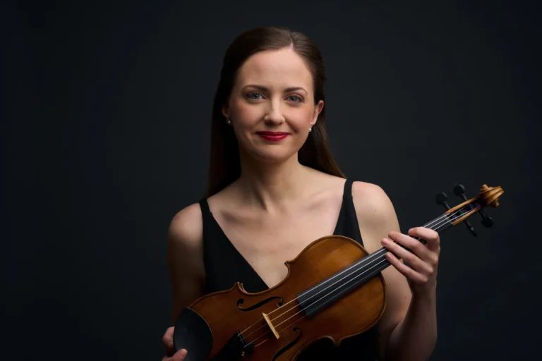 A woman holding her violin