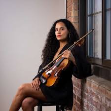 A woman holding her violin