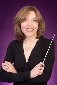 A woman holding a conductor's baton