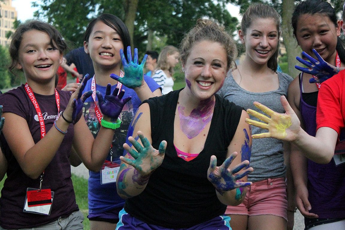 WCATY participants show off their hands after doing finger painting