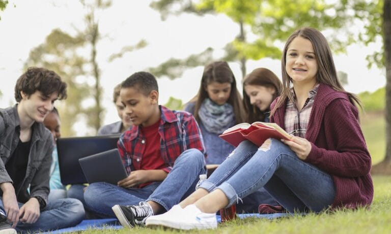 Group of teens studying in a park