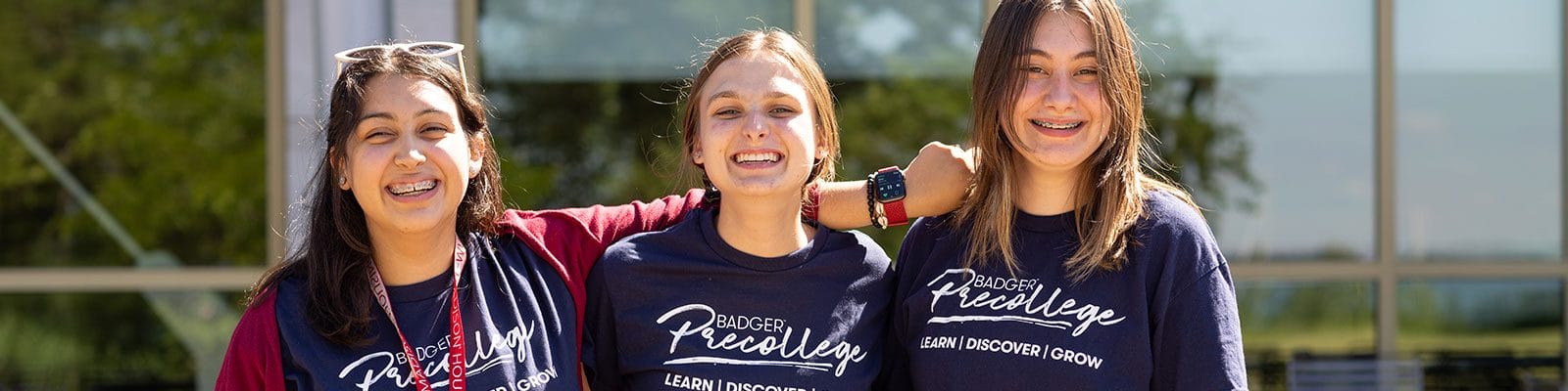 Badger precollege scholars joined arm in arm on a sunny day