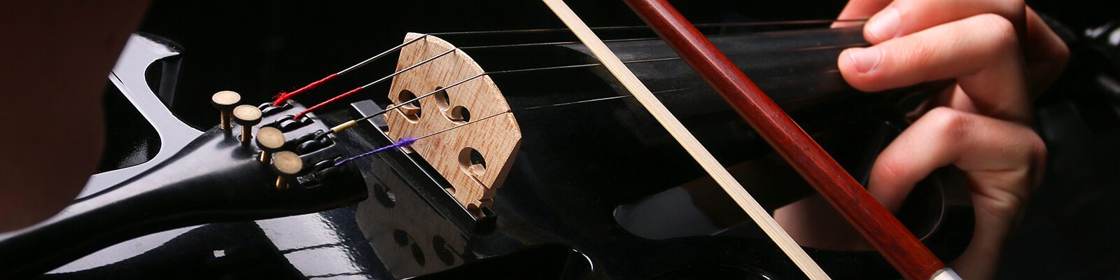 close up of someone playing a violin