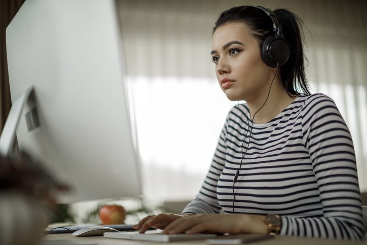 Young woman working at home on computer