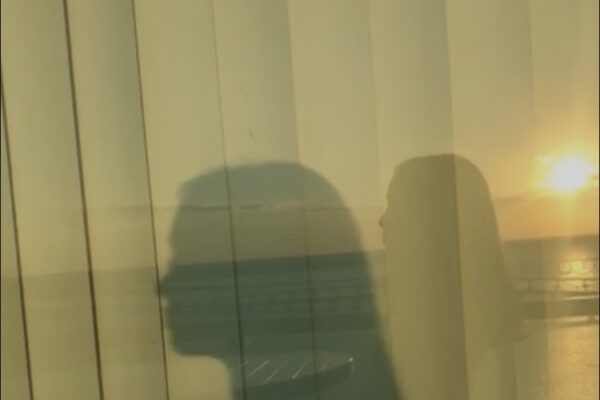 Shadow of student with sun in background