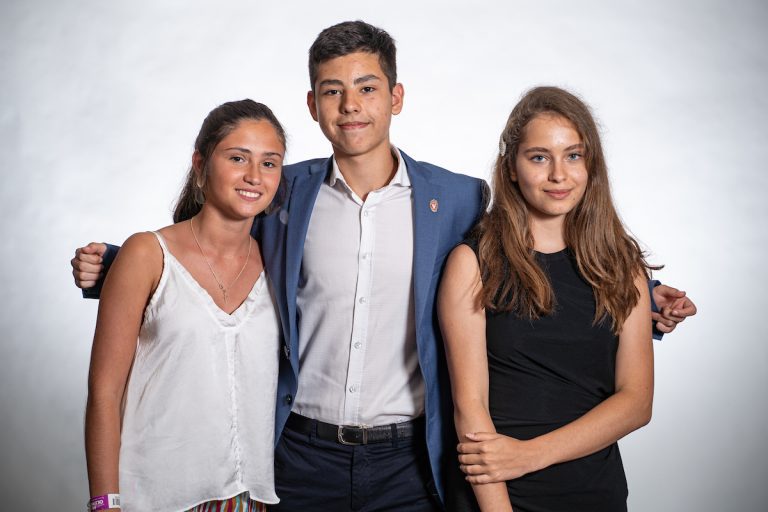 Three students posing for a photo together.